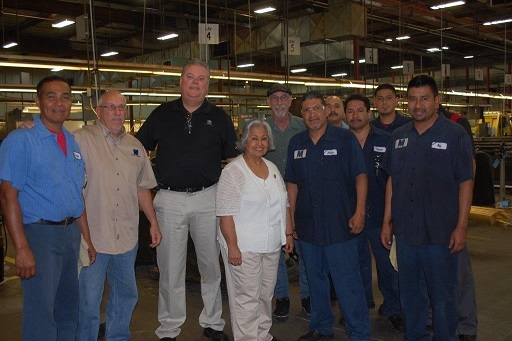Congresswoman Gloria Negrete McLeod shown with members of the Metric Machining shop team.